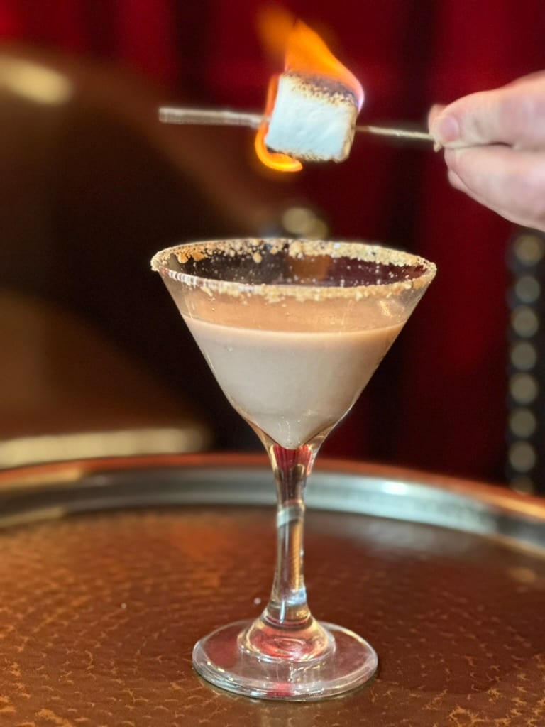 A toasted-marshmallow martini being torched at the bar
