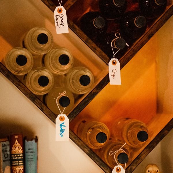 Hand-labelled bottles of house spirits in the rack